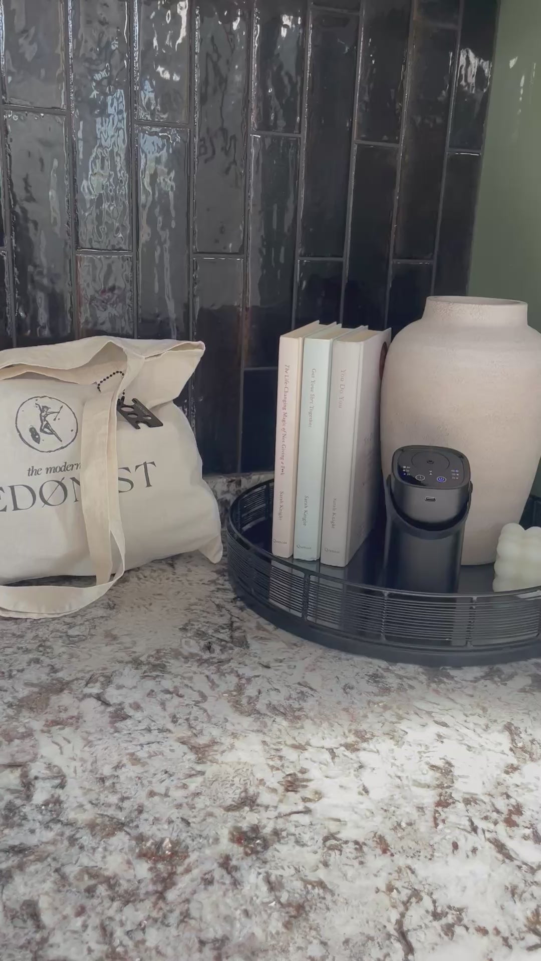 Video of the luxury modern hedonist organic cotton tote bag with essential oil keychain attached, getting ready to take the portable wellbeing diffuser to yoga